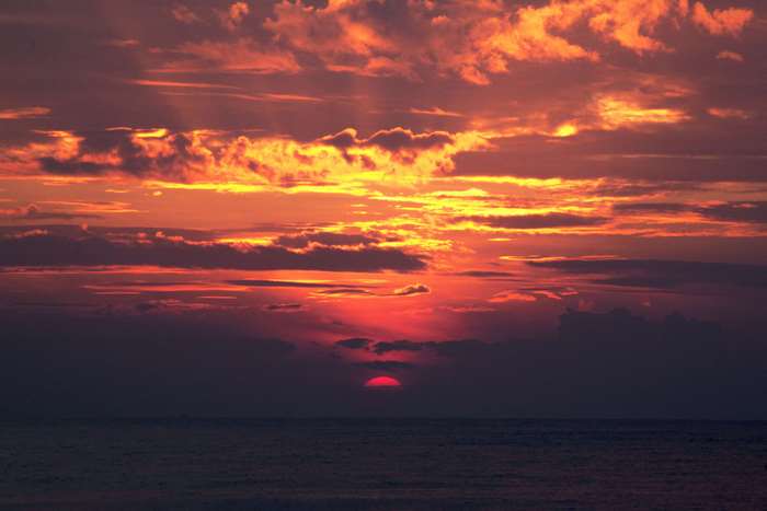 Sunset over the ocean with dramatic clouds