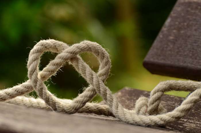 Rope tied in a heart shape on wood