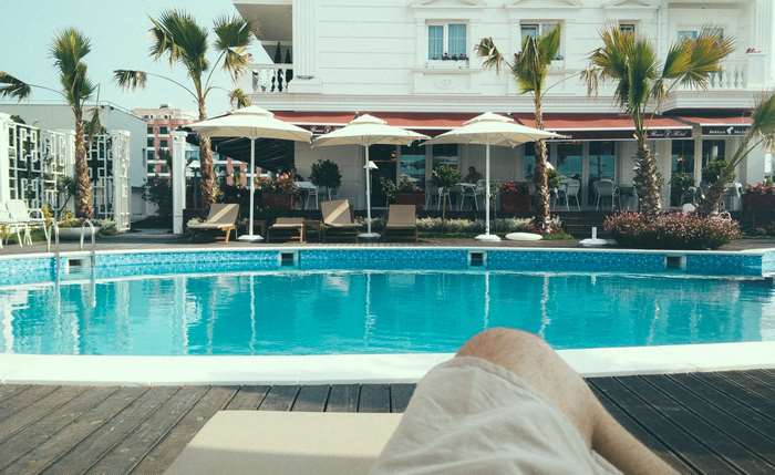 Hotel poolside with swimming pool and umbrellas