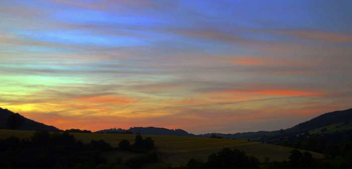 Sunset over rolling hills with colorful sky