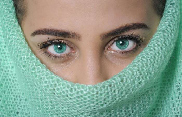Close-up of Woman with Striking Blue Eyes in Green Knit 4K