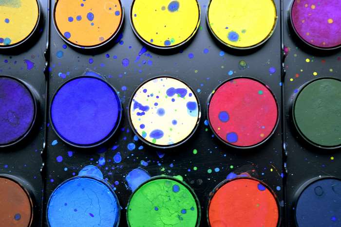 Watercolor paint palette with colorful splatters