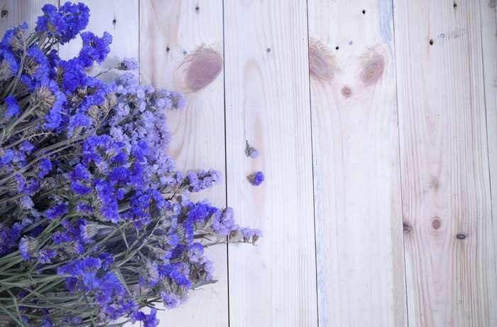 Dried blue flowers on a wooden surface