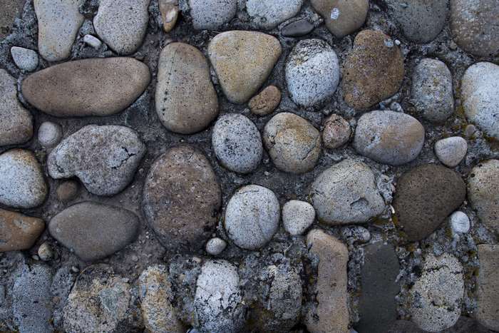 Texture of a stone wall with various rocks