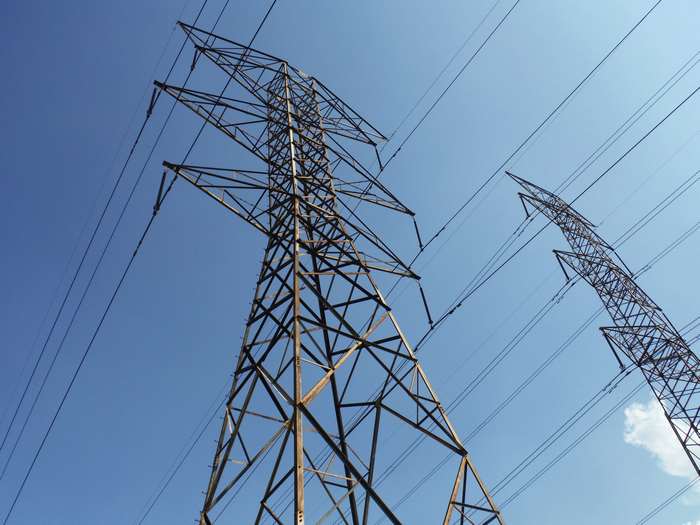 Electrical transmission towers against a clear blue sky