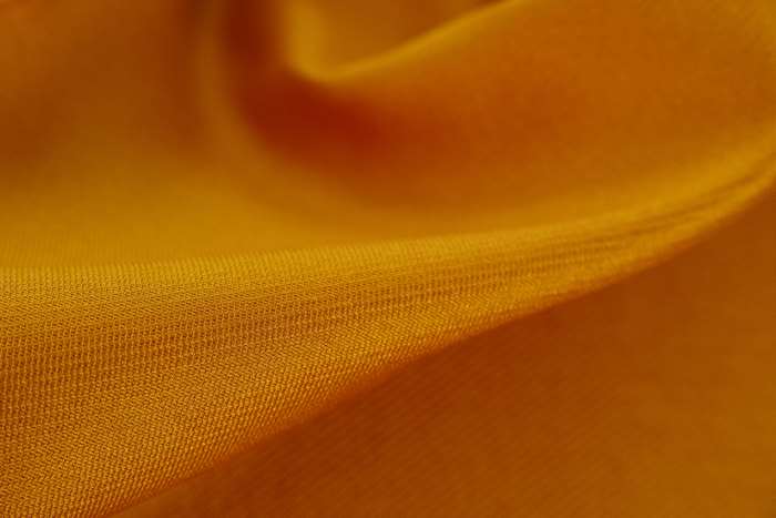 Close-up of golden textile texture 4K