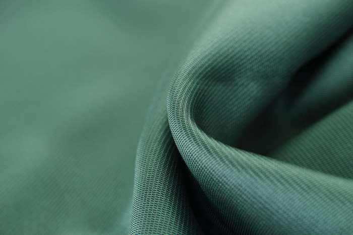Green fabric texture with selective focus