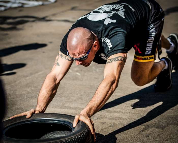 Athlete performing tire flip workout
