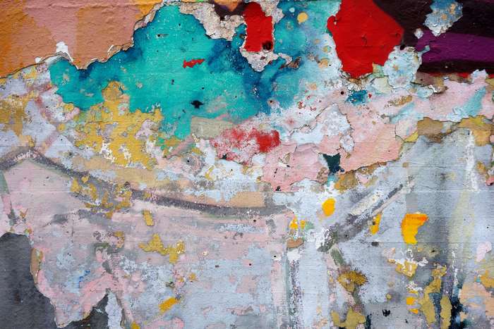 Peeling graffiti wall art with vibrant colors