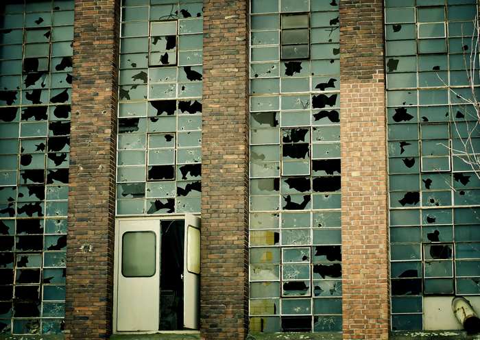 Abandoned industrial building with broken windows