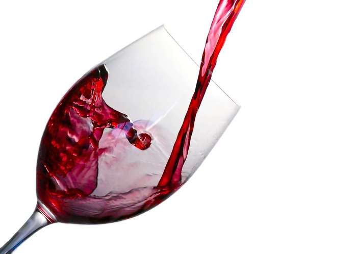 Red wine being poured into a wine glass