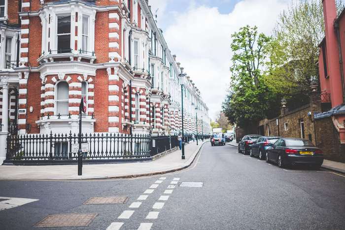 Terraced houses and cars on a London street 4K