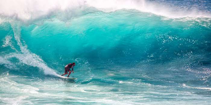 Surfer riding a large wave in the ocean
