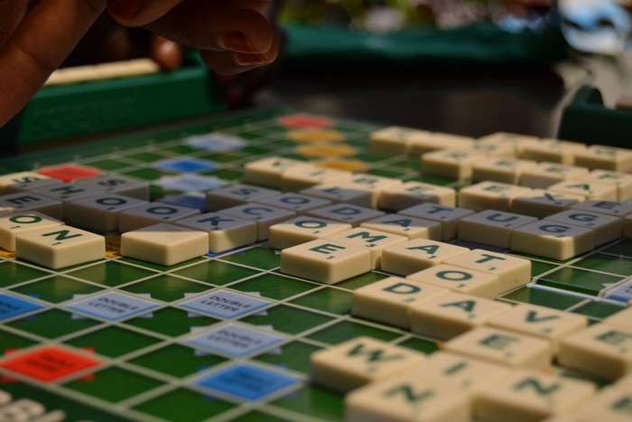 Scrabble board with tiles and hand