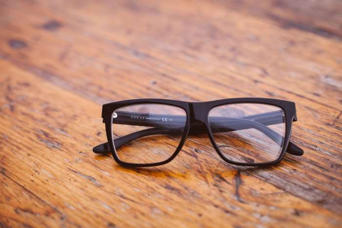 Gucci eyeglasses on a wooden table