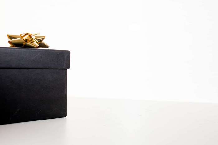 Black gift box with gold bow