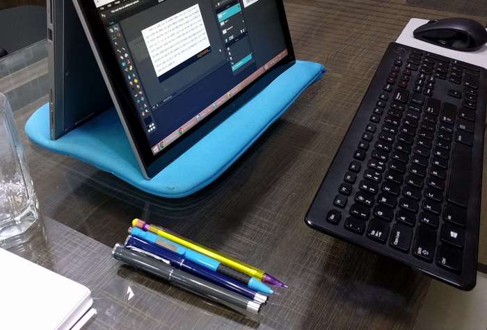 Laptop on a blue stand with keyboard and mouse