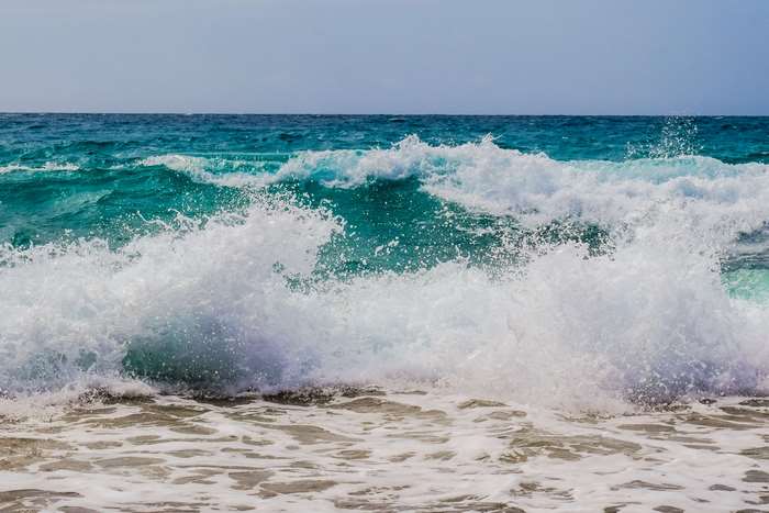 Ocean waves crashing on a sandy shore