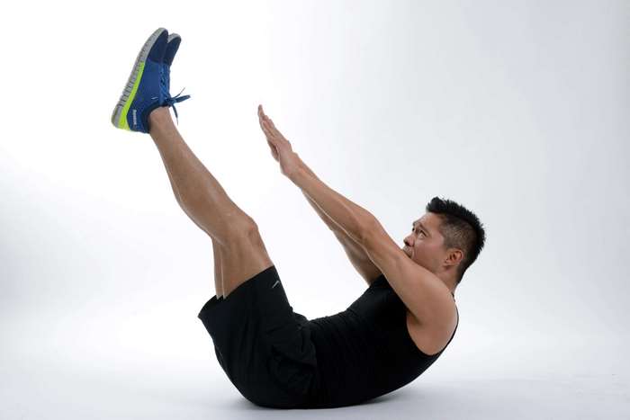 Man performing V-ups exercise