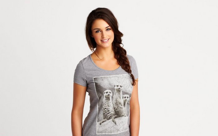 Smiling blonde woman in meerkat print t-shirt