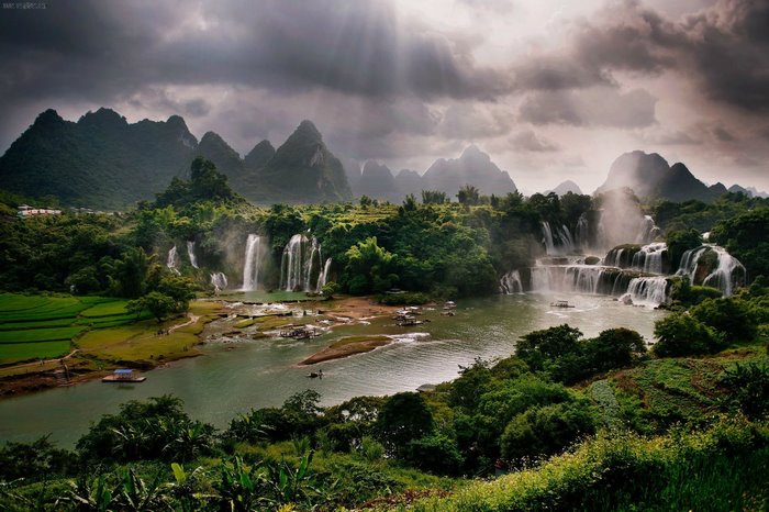 Waterfalls and mountains with sunbeams