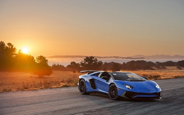 Blue Lamborghini Aventador LP-750 convertible at sunset