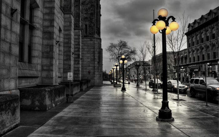 Street with lampposts and buildings at dusk