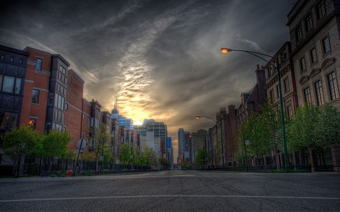 Street view of buildings and road at dusk