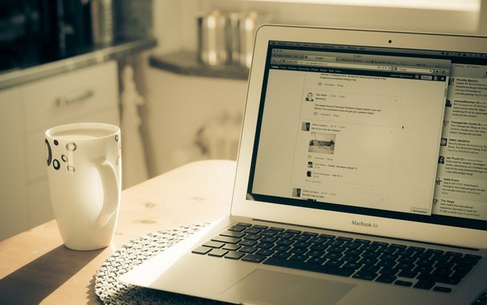 MacBook Air with a cup of coffee on a table