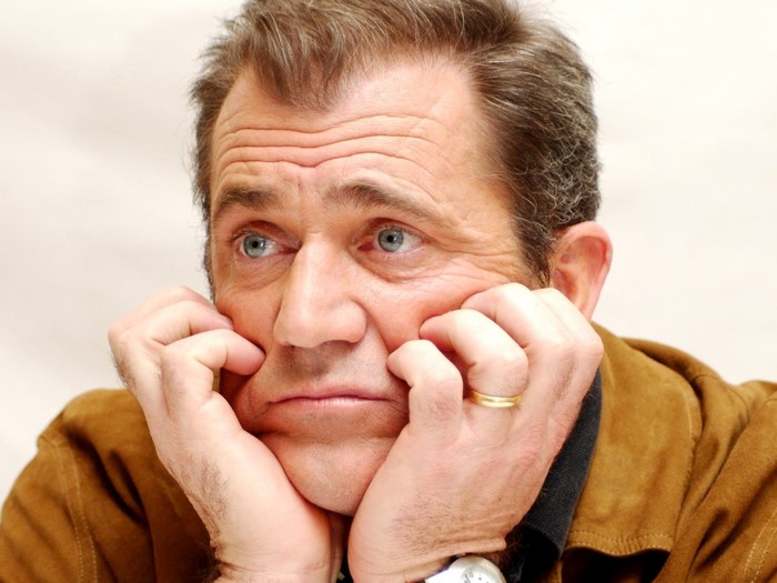 Mel Gibson with hands on face