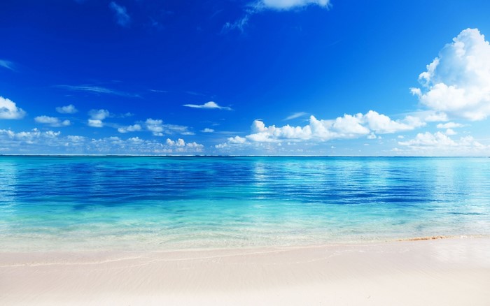 Tropical beach with clear blue ocean and white sand