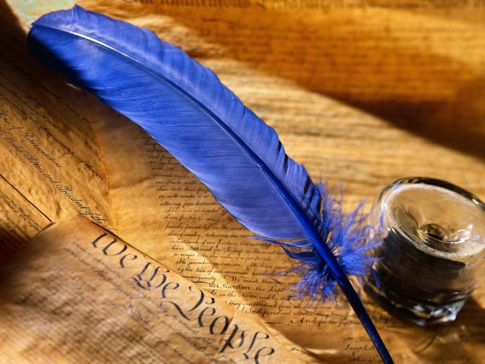 Blue quill pen on historical document