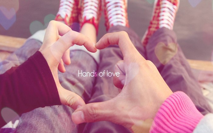 Couple making a heart shape with their hands