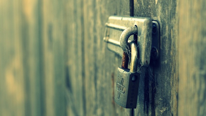 Old padlock on a wooden door