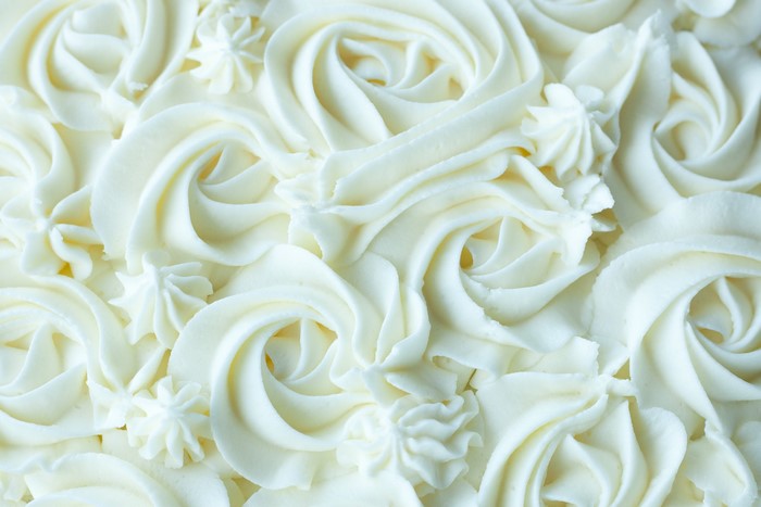 Close-up of white frosting swirls on a cake