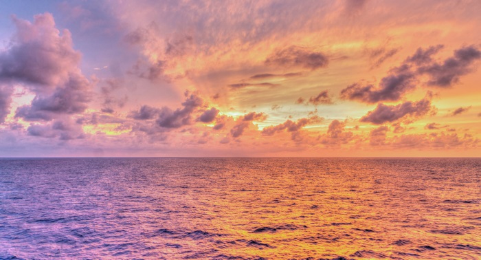 Sunset over the ocean with colorful clouds