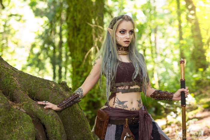 Elf cosplayer with tattoos in a forest