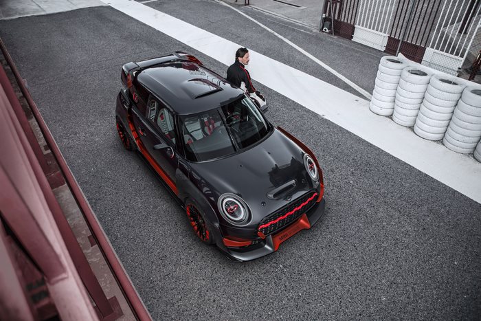Modified black Mini Cooper with red accents on track