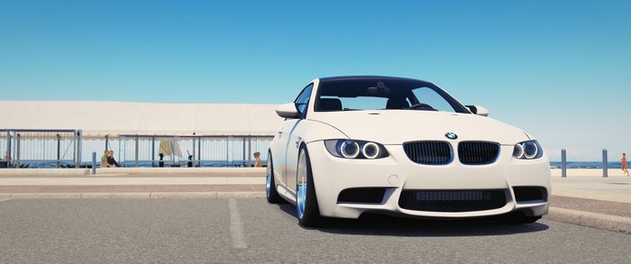 White BMW M3 parked by the beach