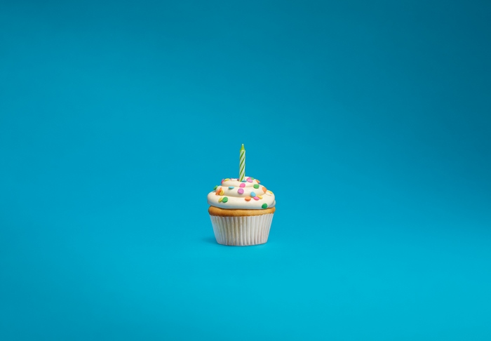 Minimalist cupcake with a single candle