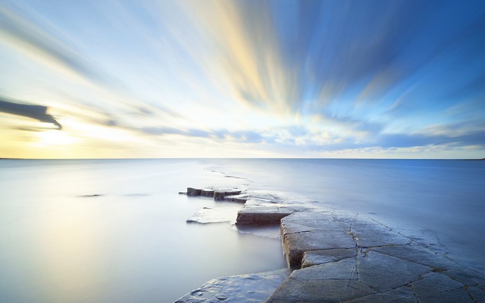 Long exposure of sea and sky with rocks