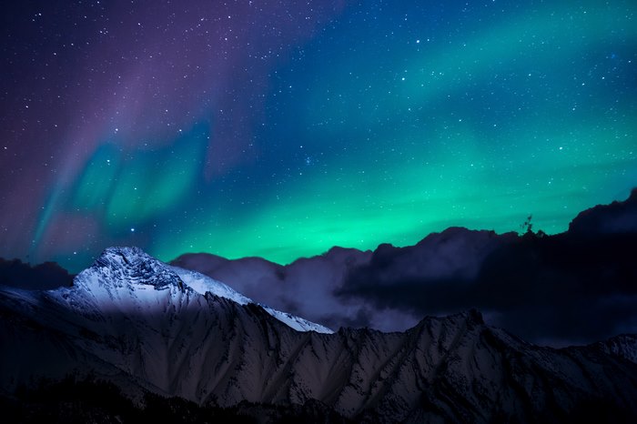 Aurora Borealis over snow-capped mountains