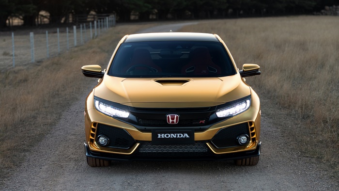 Gold Honda Civic Type R on a dirt road