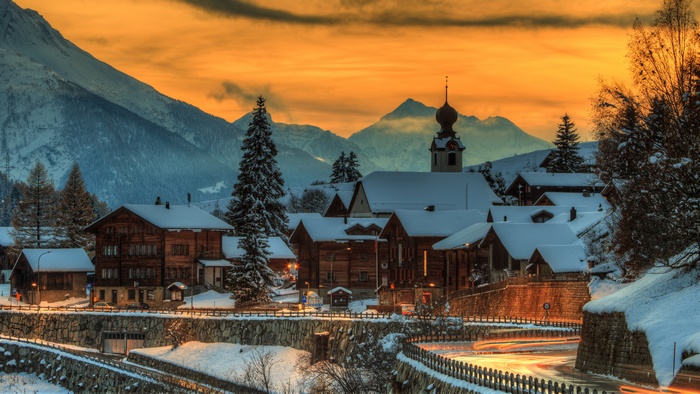 Snowy village in Switzerland at sunset