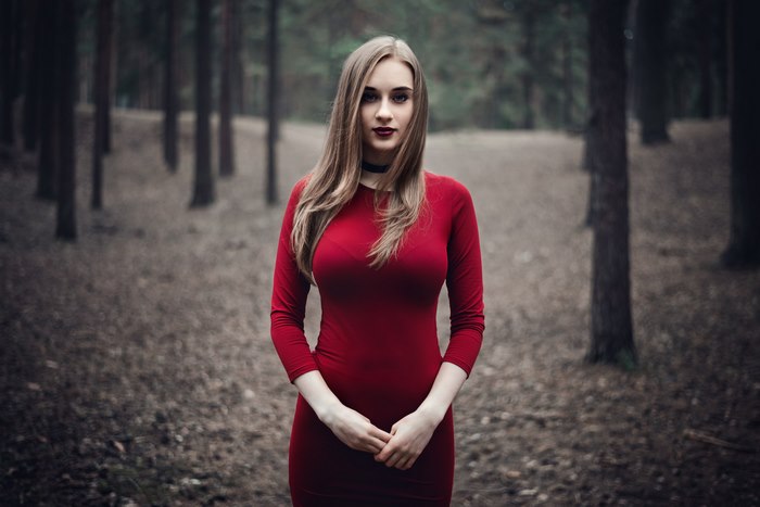 Woman in red dress in forest