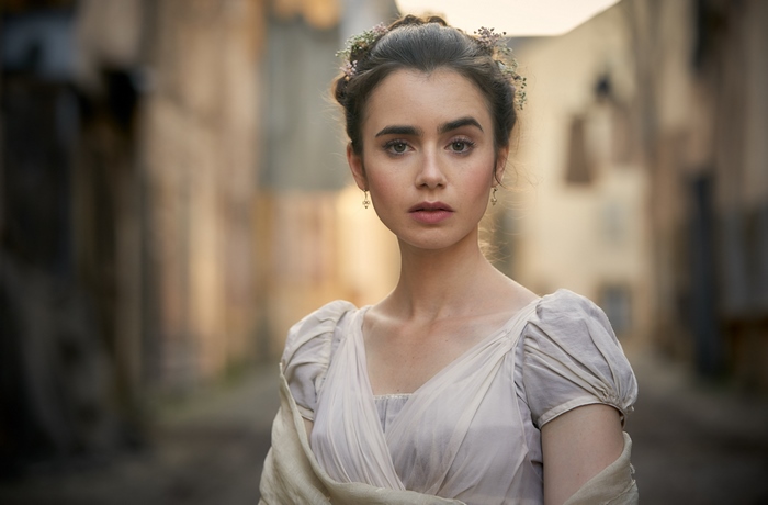 Lily Collins in a period dress with flowers in her hair