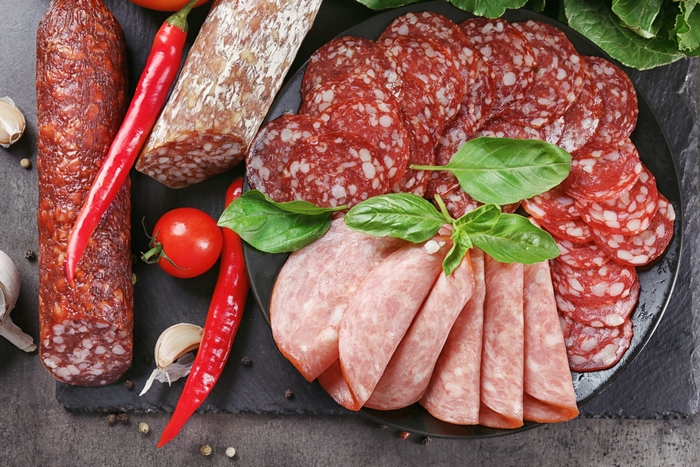 Assortment of Salami and Cured Meats with Chili Peppers and Basil