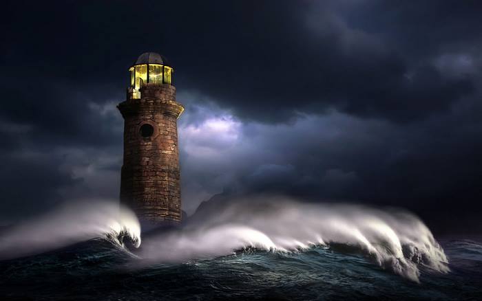 Stone lighthouse in a stormy sea with large waves