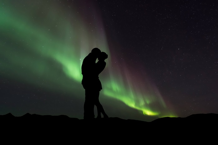 Couple kissing under the Northern Lights 4K