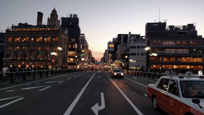 Taxi driving on a street in Japan at dusk